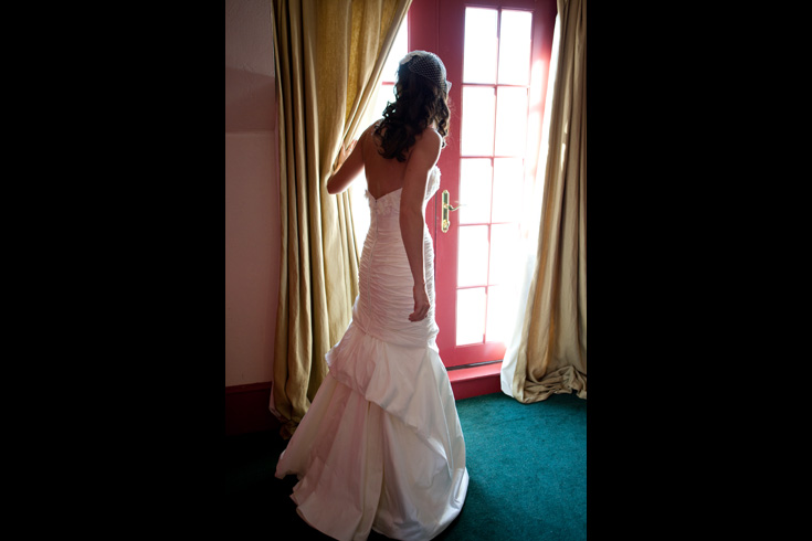 wedding pictures bride by window 